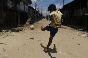 Junge spielt Fußball in Peru
