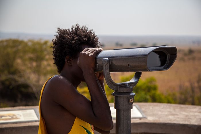 Woman looking through Telescope_Uganda